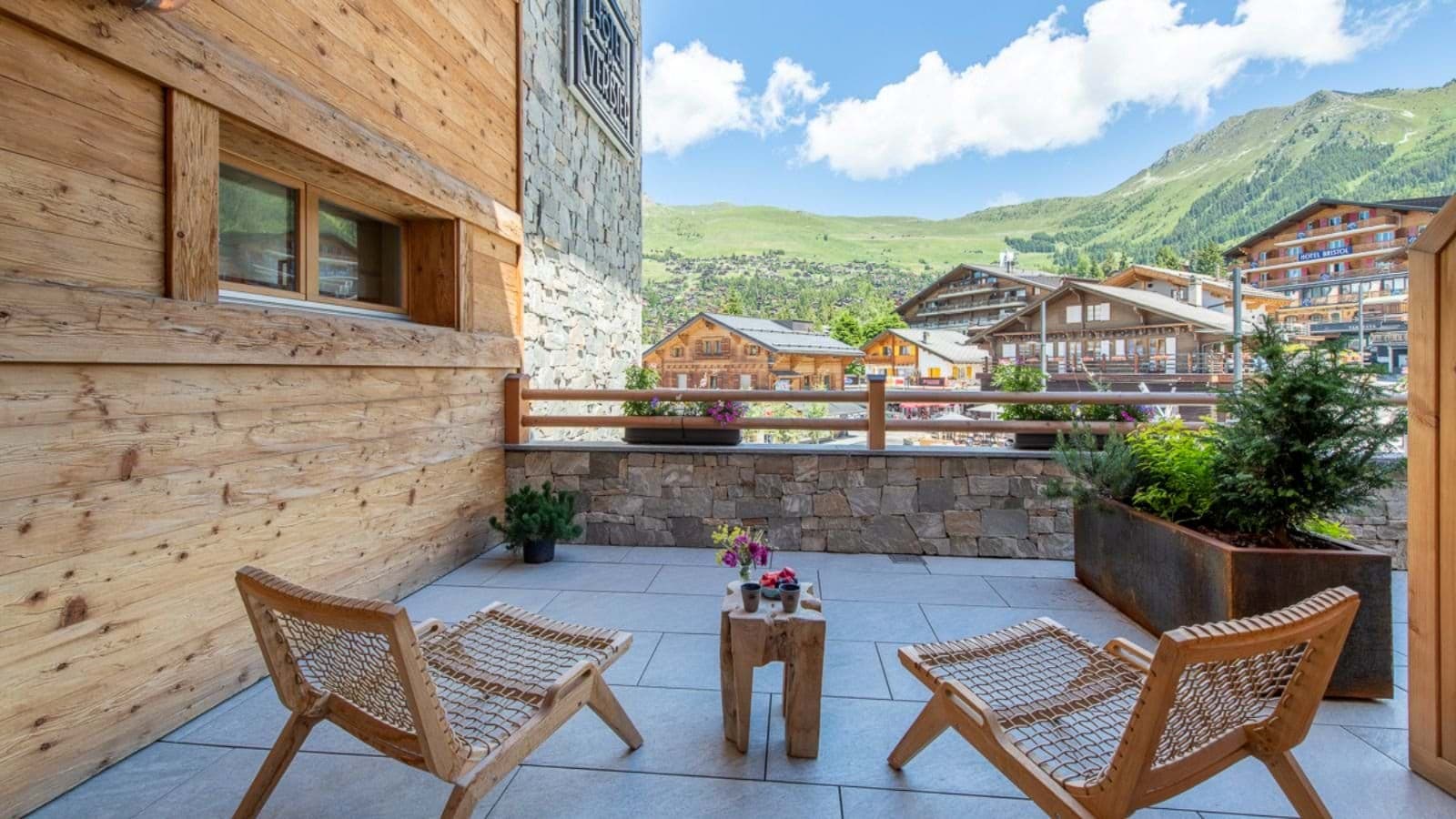 Private stone terrace with lounge seating and Verbier village views