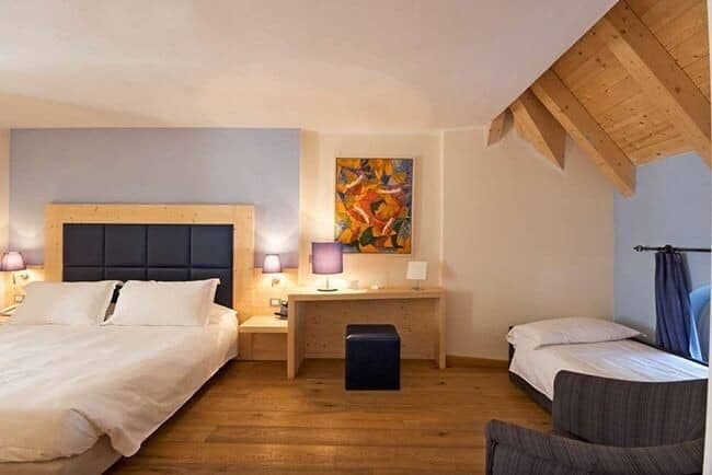 Guest bedroom with king bed, twin daybed, and integrated desk