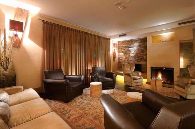 Living area with wood-burning fireplace and leather armchair seating for 6