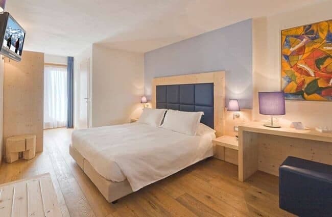 Bedroom with king bed and dedicated workspace featuring a wooden desk