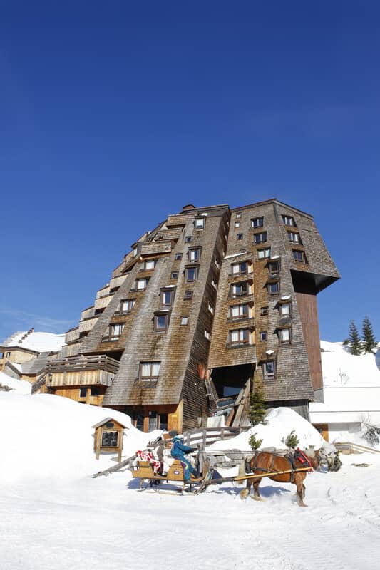 Ski-in/ski-out chalet with timber shingle facade and horse-drawn sleigh access