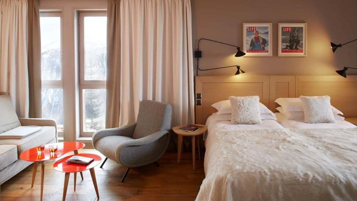 Bedroom with twin beds and mountain-view seating area