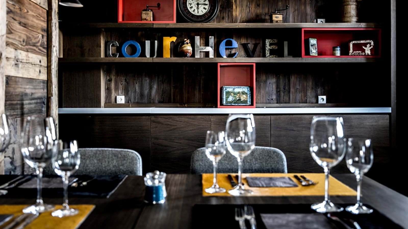 Dining table with stemware and reclaimed wood shelving