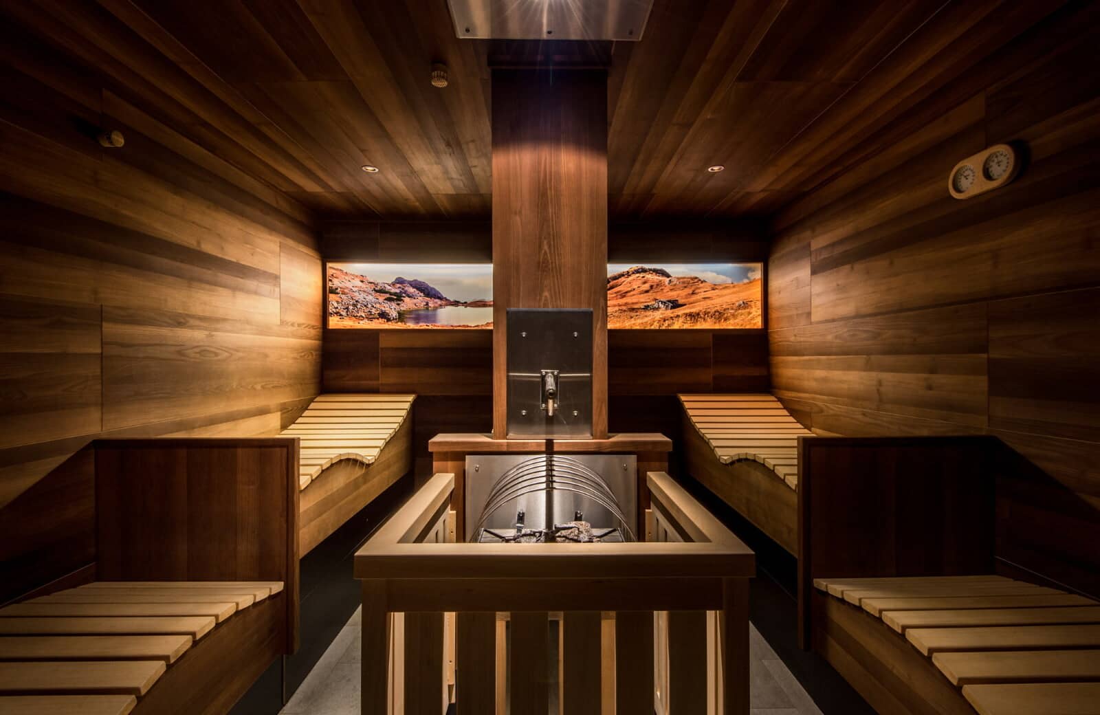 Cedar-lined sauna with four ergonomic loungers and central heater