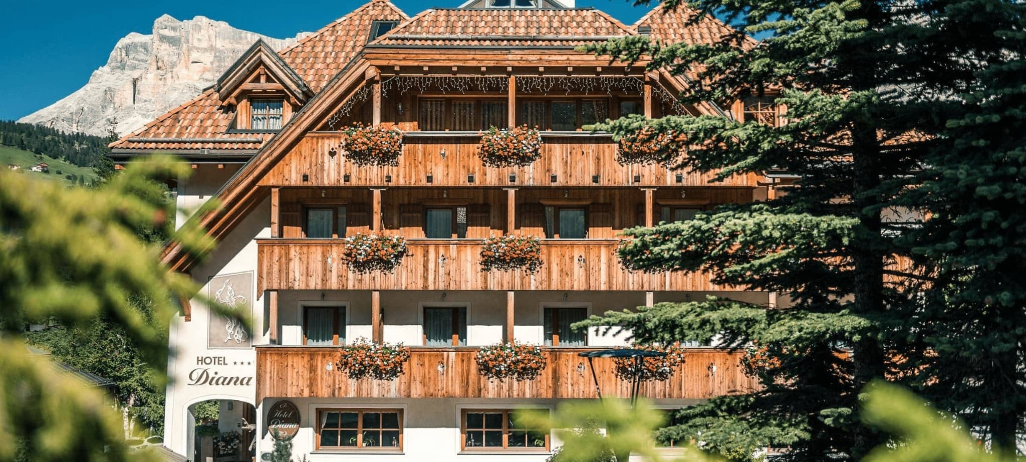 Chalet exterior with private wooden balconies and Dolomite mountain views
