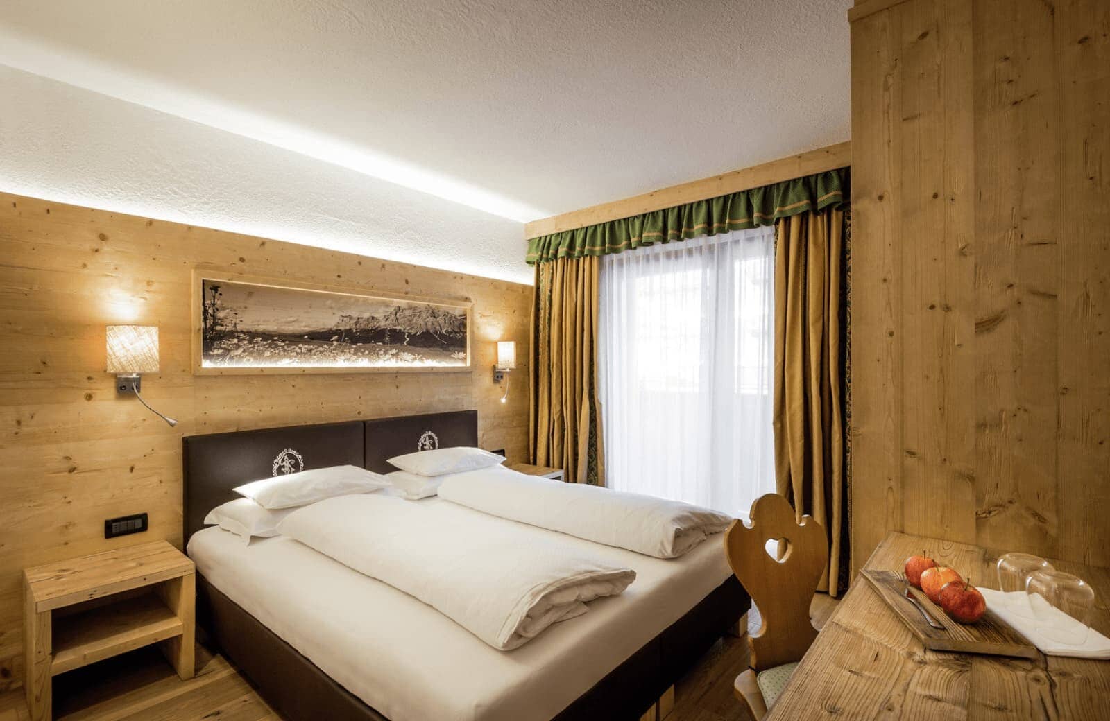 Bedroom with king bed, knotty pine paneling, and private balcony access