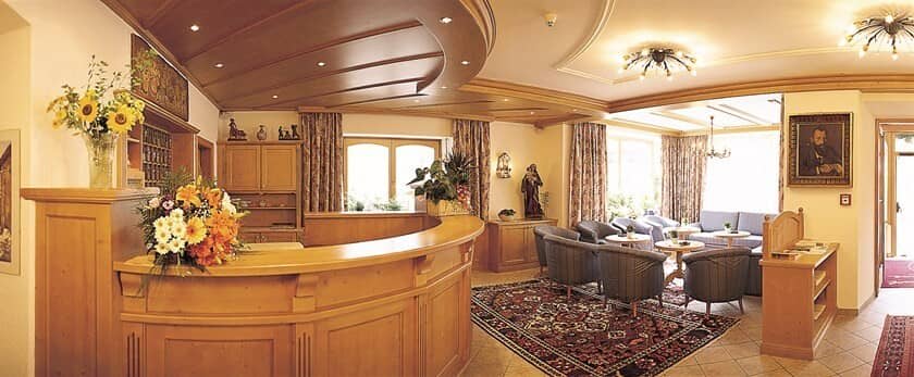 Reception desk and guest lounge with armchair seating for 10