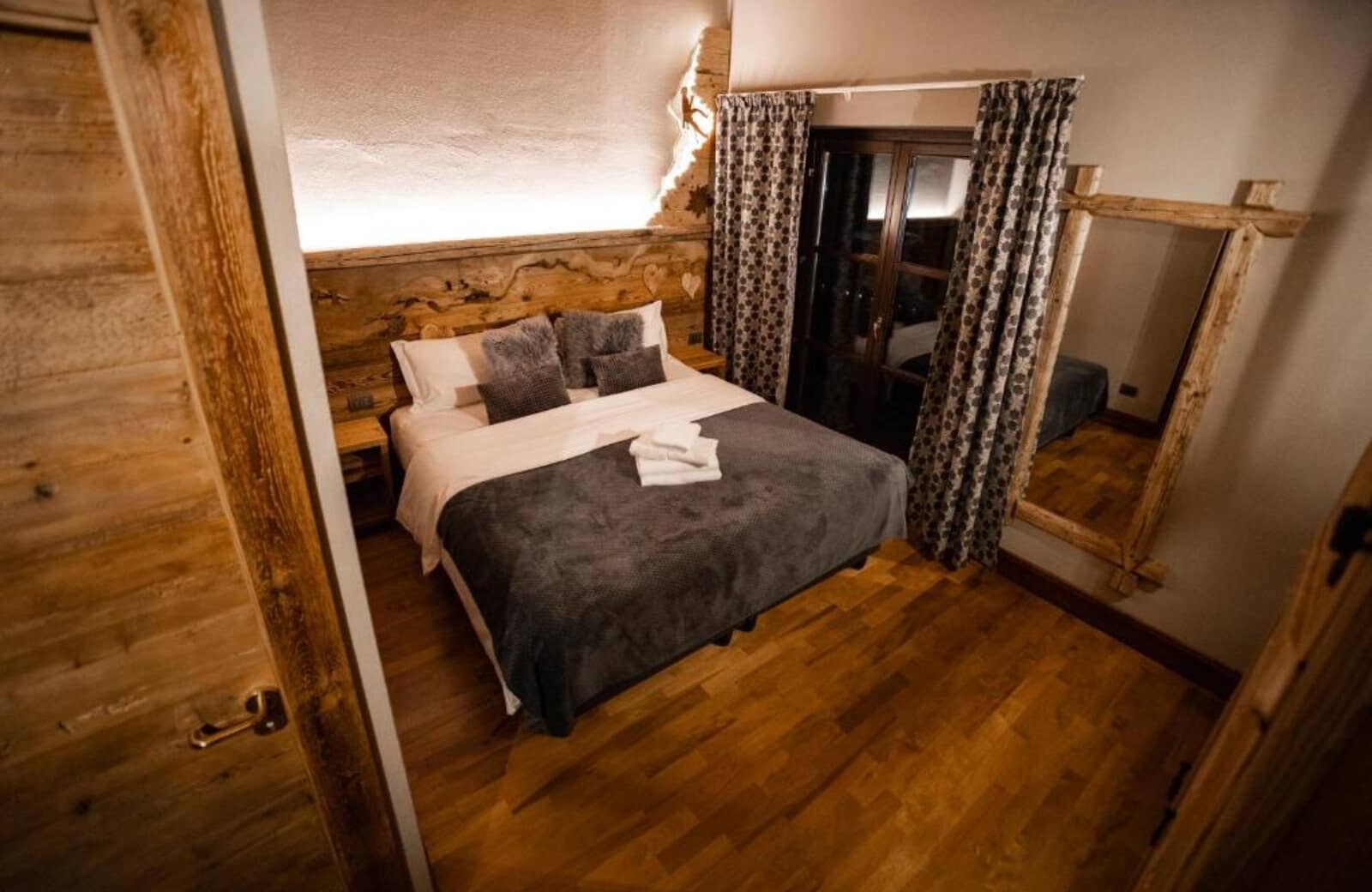 Bedroom featuring backlit wood headboard and sliding door access to outdoors