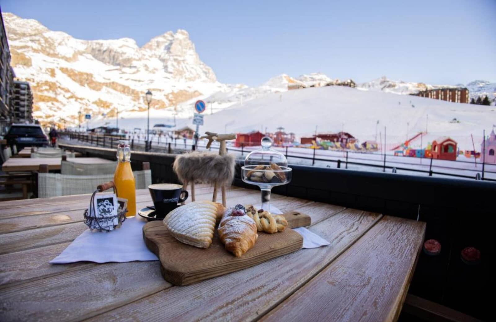 Outdoor terrace with seating and views of the surrounding ski area