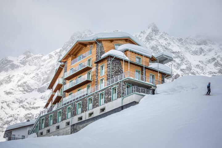 Ski-in/ski-out chalet with tiered balconies and stone facade