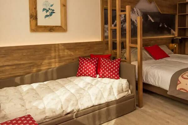 Guest bedroom with double bed and twin daybed; wood slat divider