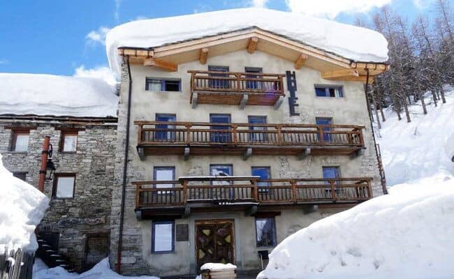 Ski-in/ski-out chalet exterior with private balconies and mountain views