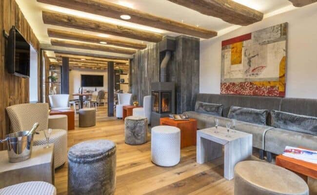 Lounge with wood-burning stove and reclaimed timber ceiling beams