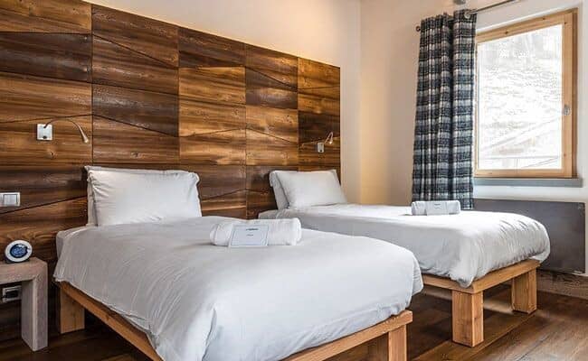 Guest bedroom with two twin beds and individual reading lights