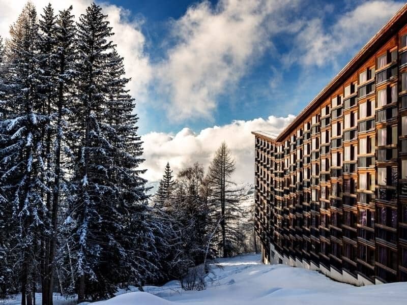 Ski-in, ski-out resort exterior with private balconies and mountain views