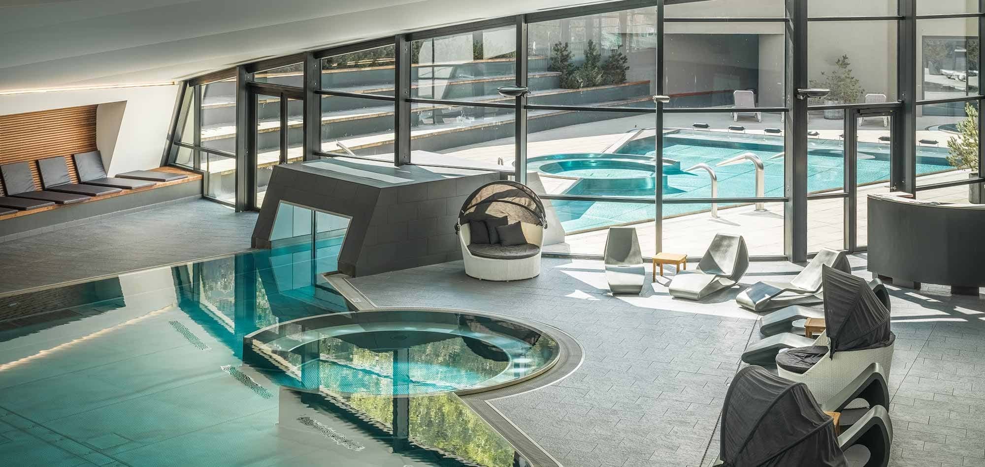 Indoor pool and circular spa with swim-through access to outdoor pool