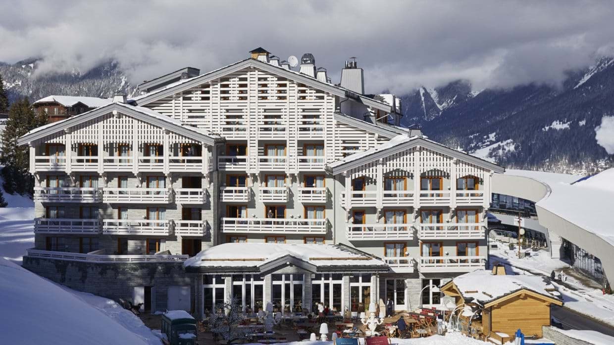 Alpine resort exterior with private balconies and mountain views