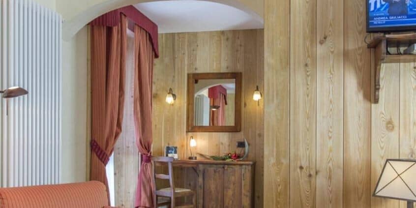 Guest bedroom nook with dedicated workspace and wood-paneled walls