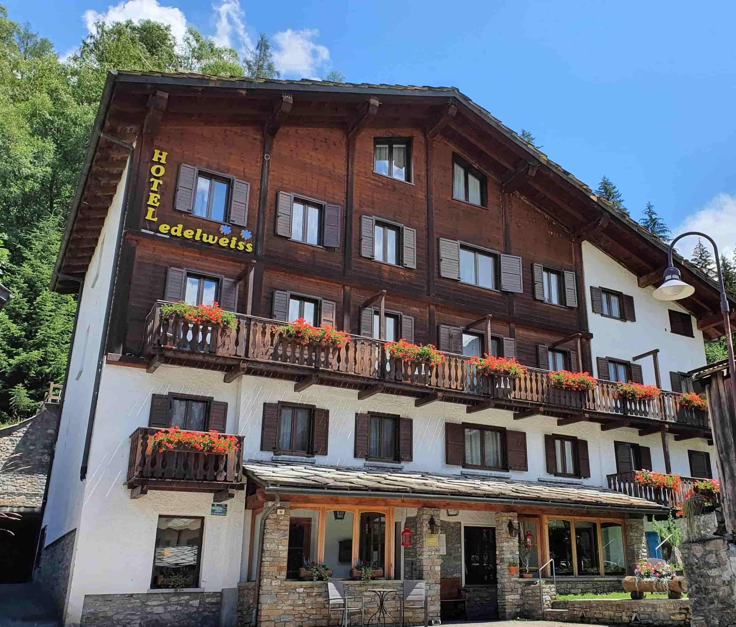 Chalet-style exterior with flower-lined balconies and stone-paved patio