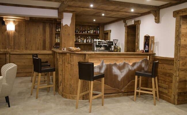 Private bar with professional espresso machine and seating for five
