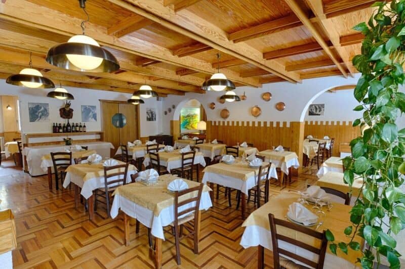 Dining room with wood-beam ceiling and seating for over 40 guests