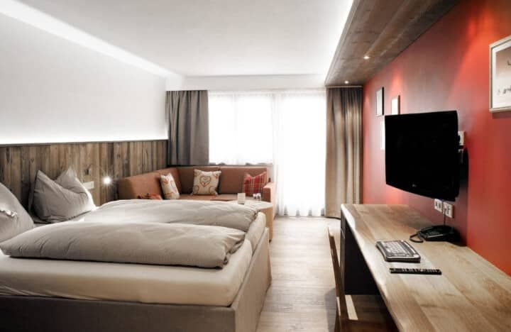 Guest suite with king bed, sofa seating area, and dedicated workspace