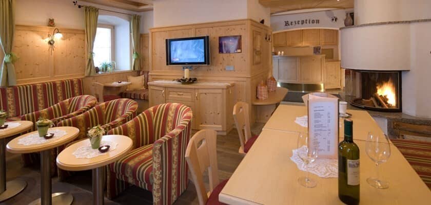 Guest lounge with wood-burning fireplace and wall-mounted TV