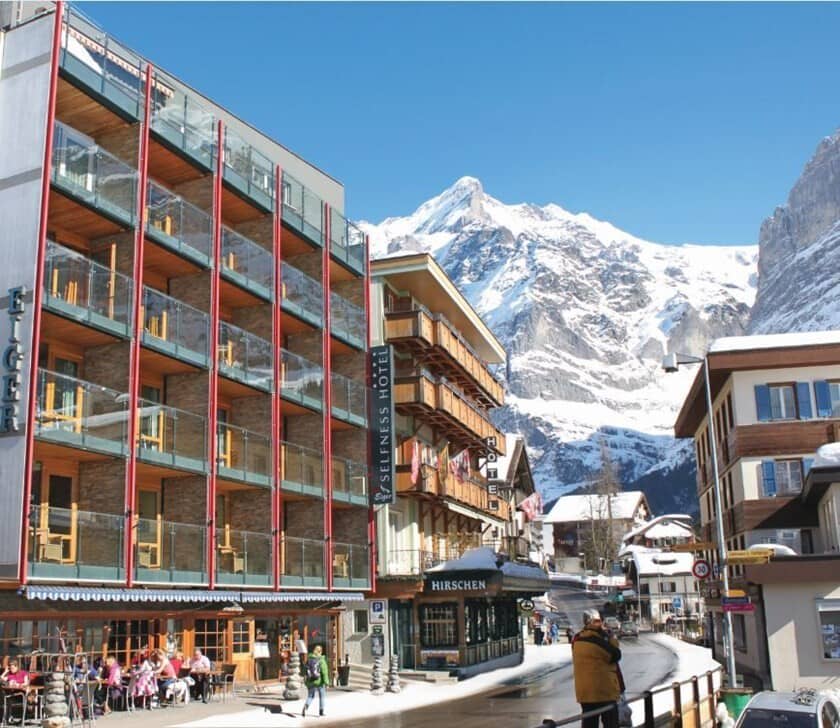 Building exterior with private glass balconies and Eiger mountain views