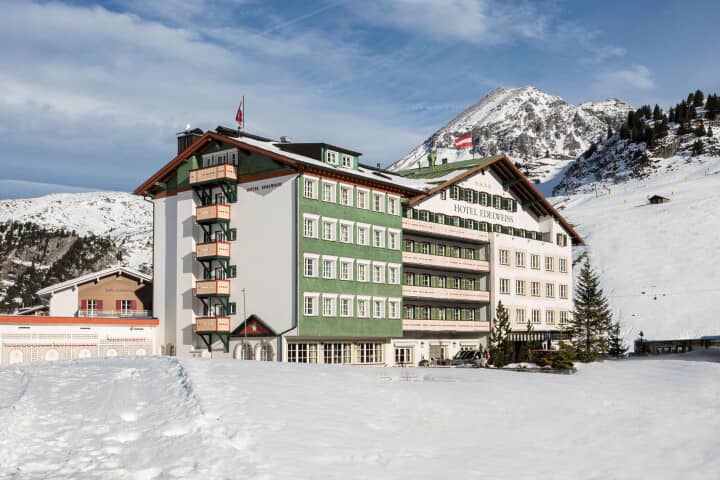 Ski-in/ski-out hotel exterior with mountain views and private balconies