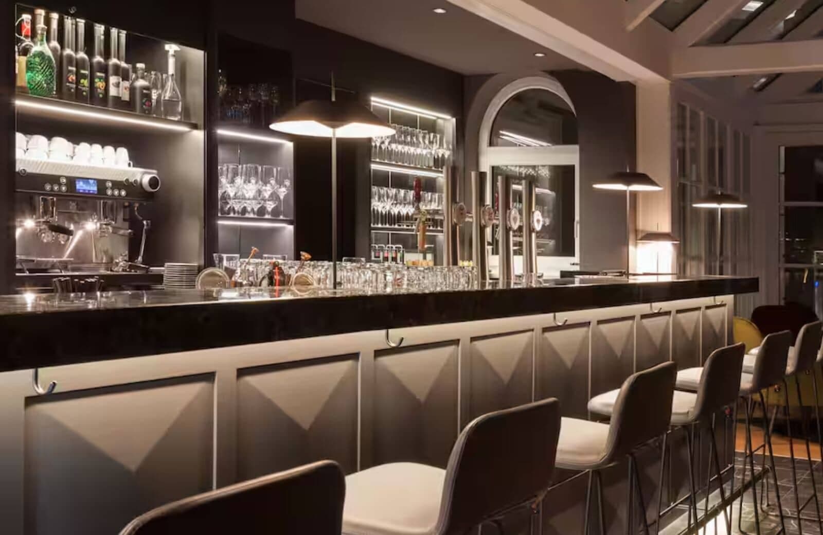 Private cocktail bar with espresso machine and stool seating for six