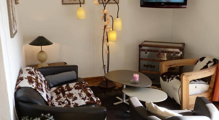 Seating area with cowhide accents and wall-mounted TV