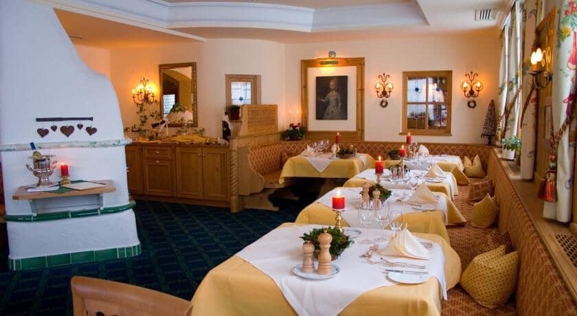 Dining room with traditional masonry heater and banquet seating for groups