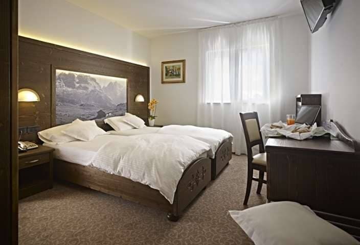 Guest bedroom with two twin beds and dedicated desk workspace