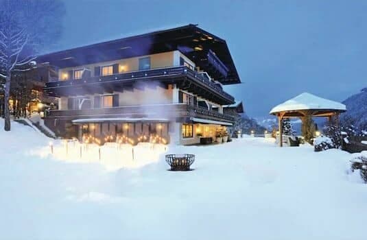 Chalet exterior with outdoor fire pit and covered gazebo seating