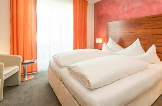 Guest bedroom with king bed and blackout curtains