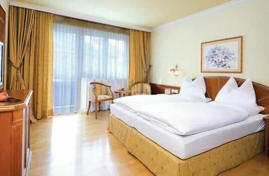 Guest bedroom with king bed and private balcony access