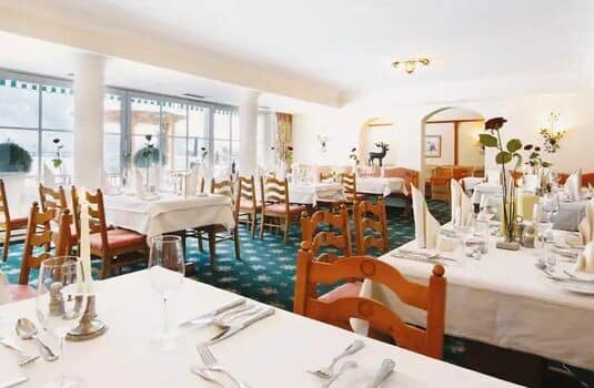 Shared dining room with floor-to-ceiling windows and terrace access