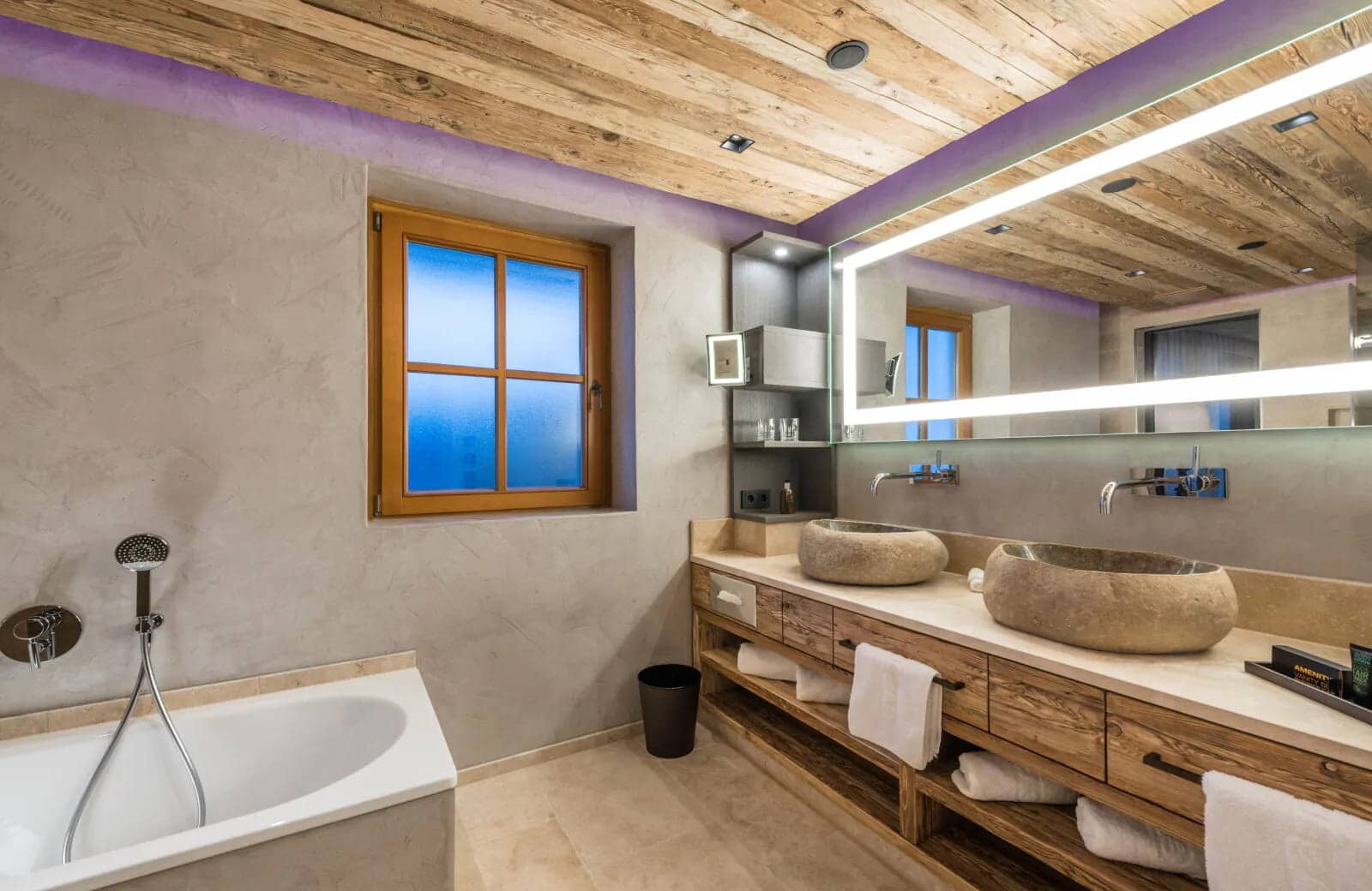 Bathroom with dual stone vessel sinks and soaking tub