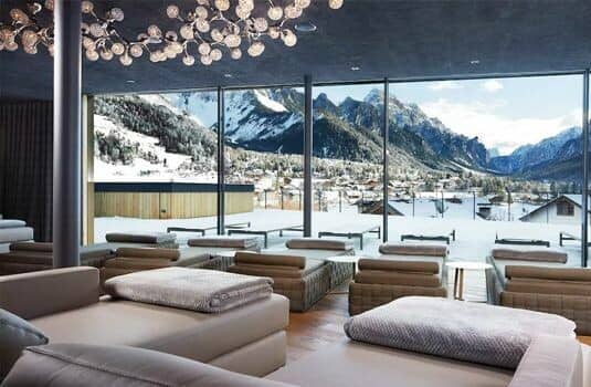 Shared lounge with daybeds and floor-to-ceiling mountain views