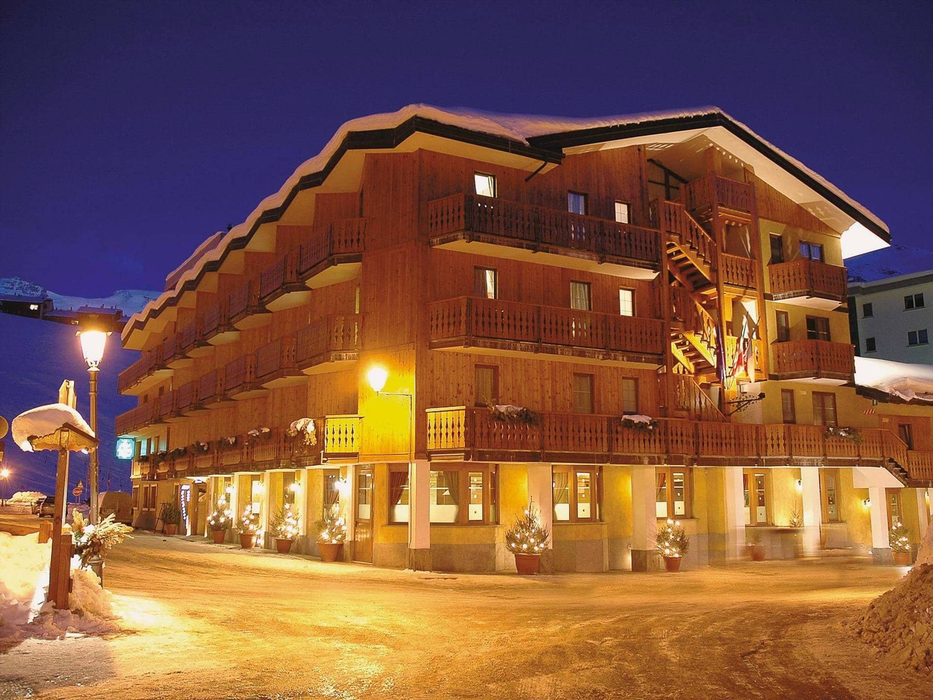 Ski-in lodge exterior with private balconies and street-level restaurant