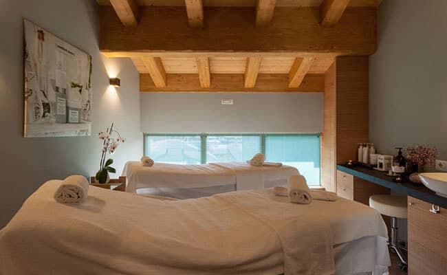 Private spa room with dual massage tables and exposed timber beams