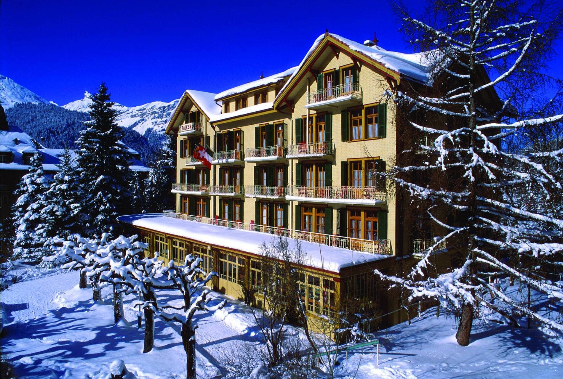 Historic alpine hotel exterior with private balconies and mountain views