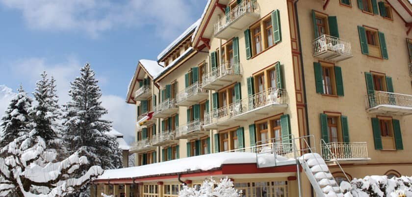 Chalet exterior featuring private balconies and snow-covered evergreen surroundings