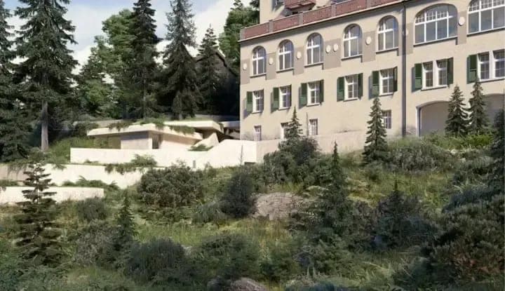 Building exterior featuring historic arched windows and terraced stone landscaping