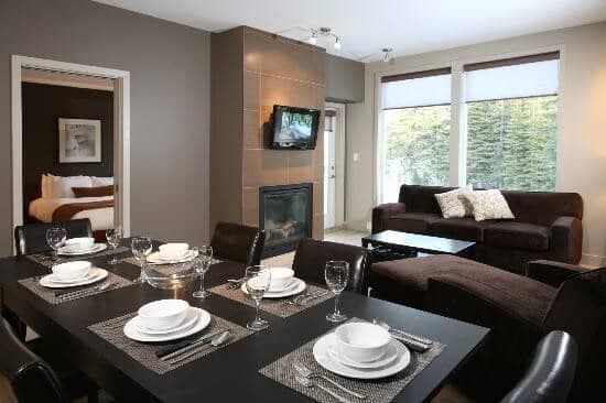 Open living area with 6-seat dining table and gas fireplace