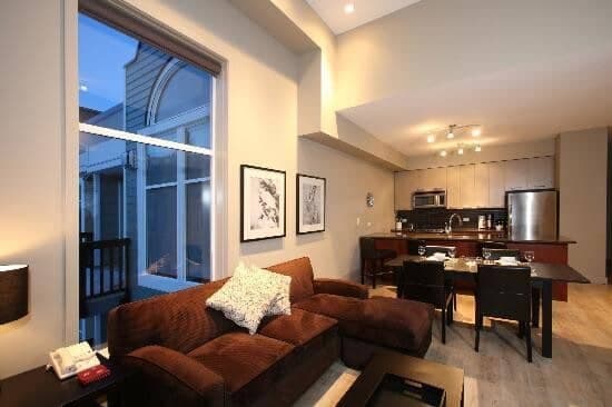 Open-plan living area with vaulted ceilings and dining seating for 4