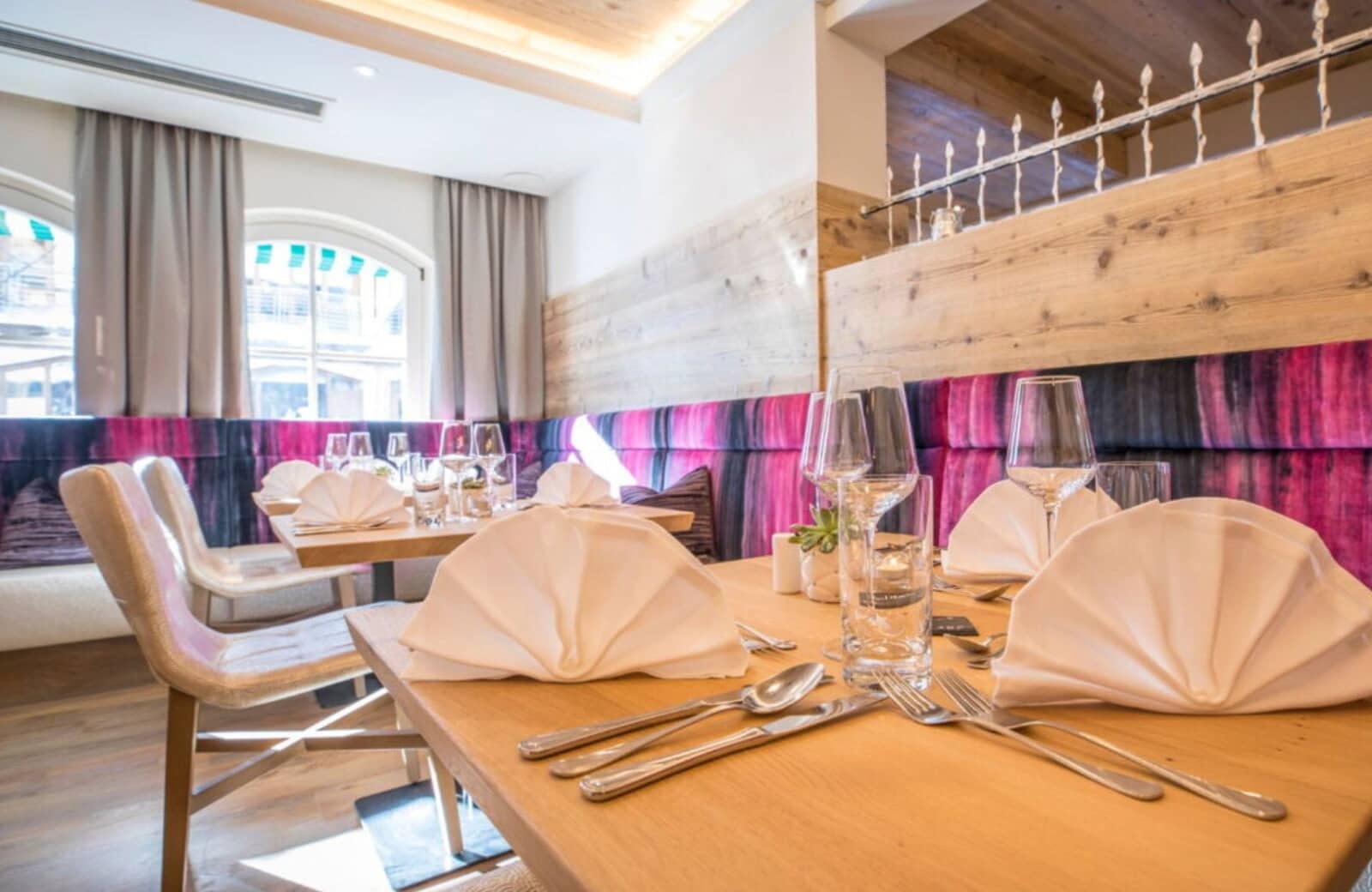 Dining area with banquet seating and wood-paneled walls