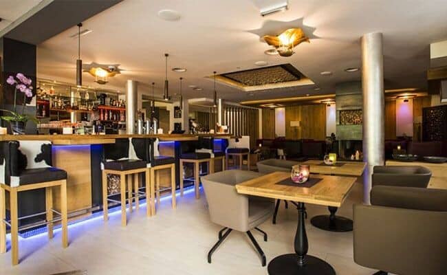 Shared cocktail bar with stool seating and table service area