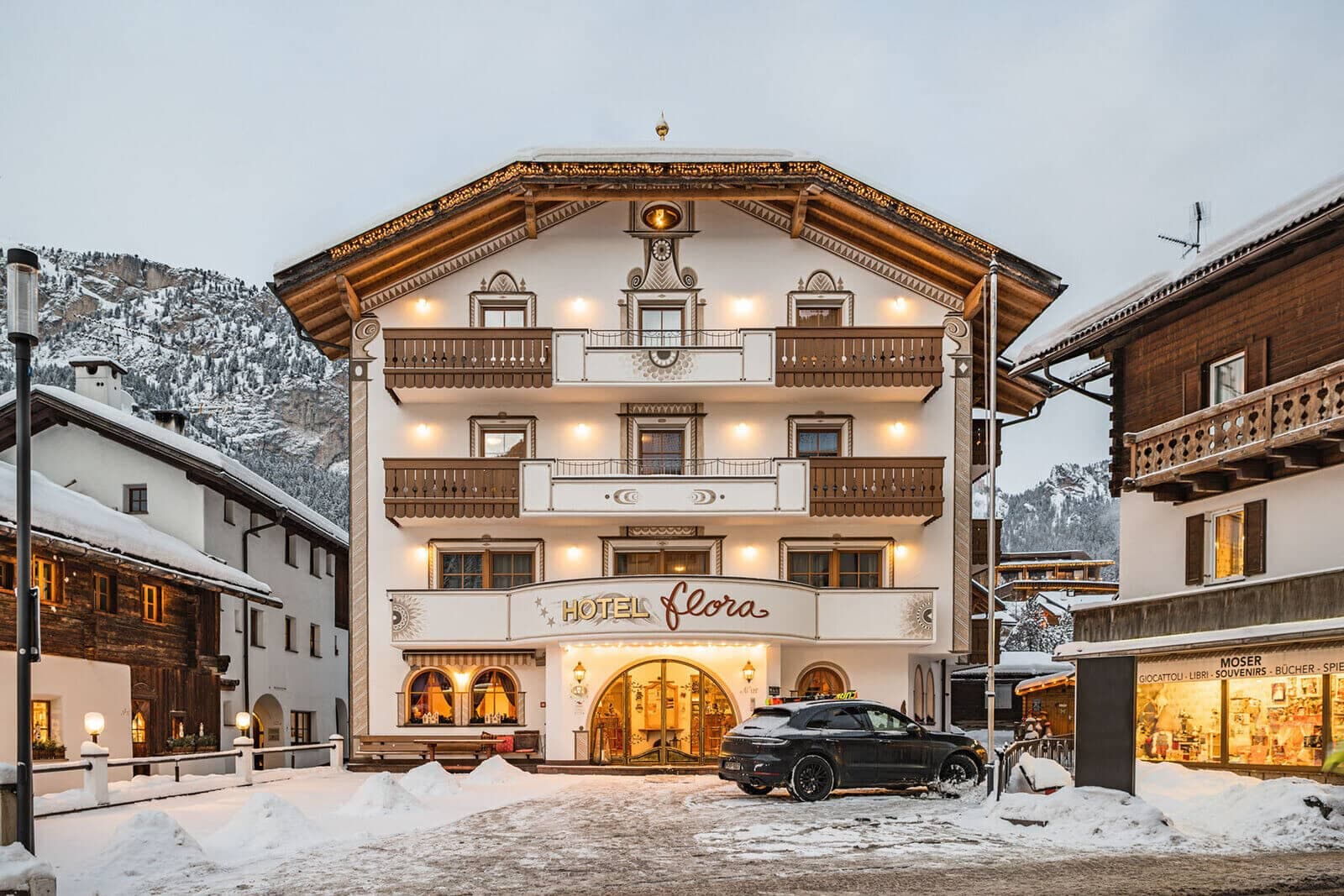 Hotel exterior with private balconies and on-site parking in village center