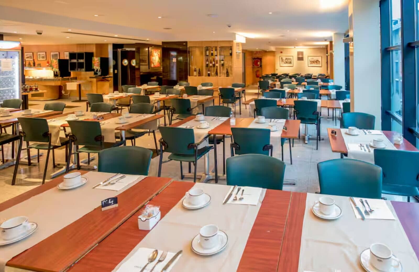 Breakfast dining room with floor-to-ceiling windows and buffet area